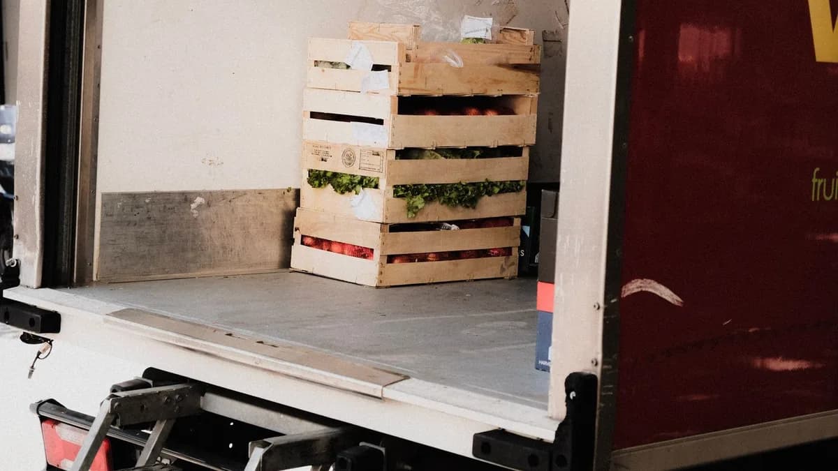 Stacked wooden crates of fresh produce loaded in a delivery truck